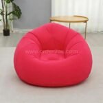 Pink inflatable bean bag chair in a contemporary room with coffee table, easy to inflate and move.