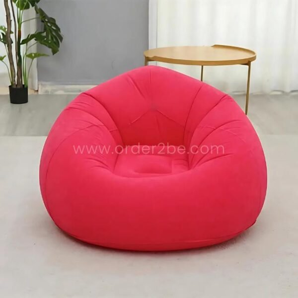 Pink inflatable bean bag chair in a contemporary room with coffee table, easy to inflate and move.