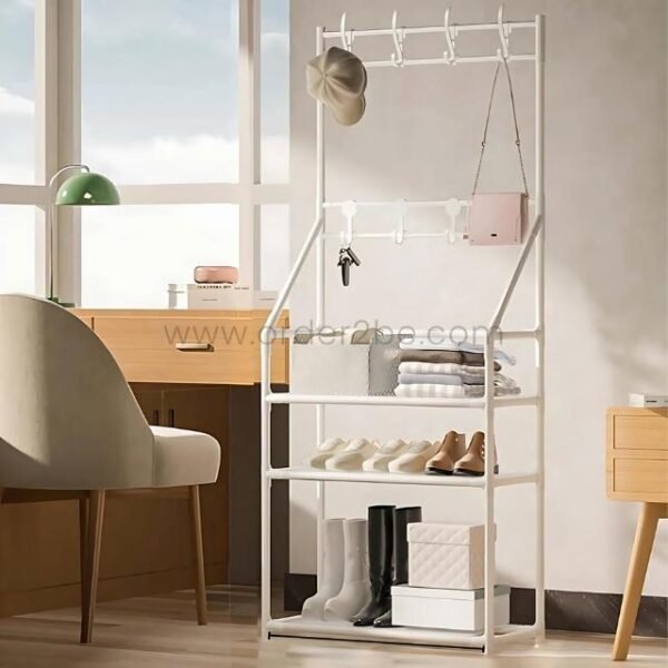 White entryway rack with shoes, folded clothes, and handbag in bright living space.